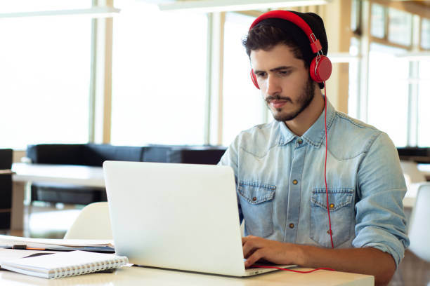 istock Young male student studying in the library. 1172562475