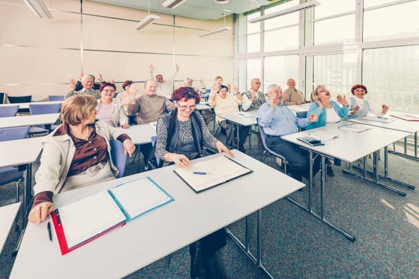 istock Group of happy seniors on motivation seminar 1172563523