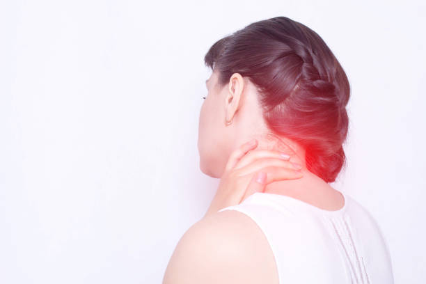 a young girl holds on to a sore neck in which the protrusion and fibromyalgia of the muscles, medical, copy space, vertebral instability - human vertebra fotos imagens e fotografias de stock