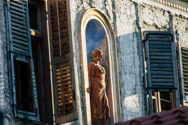 The view of a bronze nude figural body sculpture placed by the window