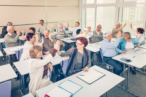istock Group of happy seniors on motivation seminar 1172563681