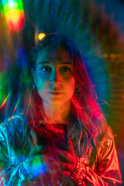istock Cool young girl at night with rainbow light effect 1172563685