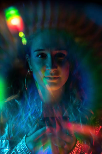 istock Cool young girl at night with rainbow light effect 1172563696