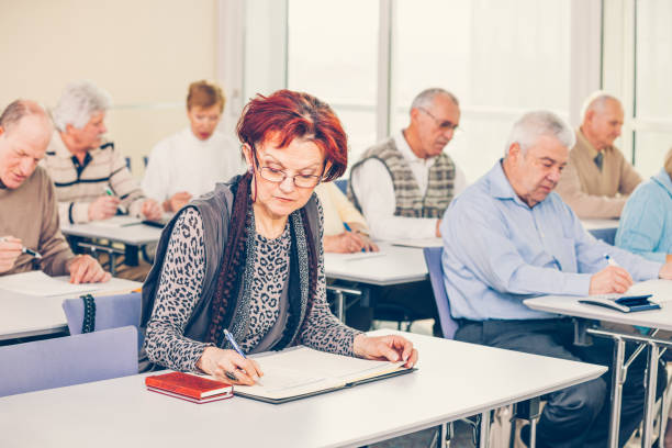 istock Group of happy seniors on motivation seminar 1172563697