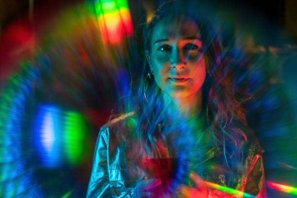 Cool young girl at night with rainbow light effect stock photo