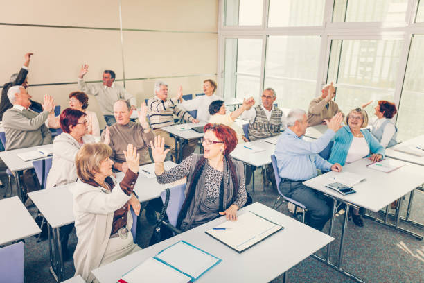 istock Group of happy seniors on motivation seminar 1172563711