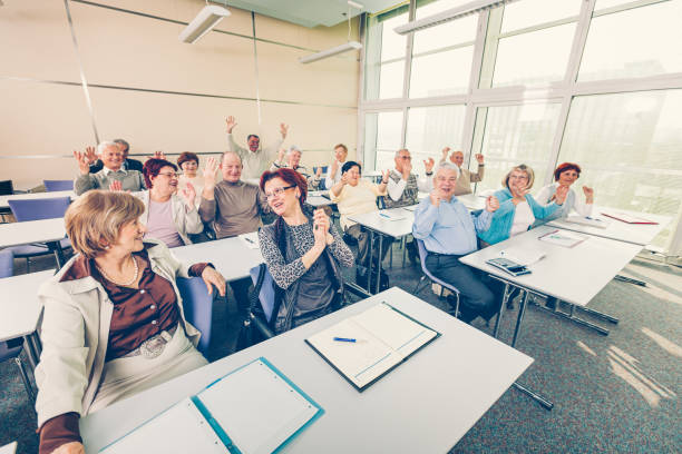 istock Group of happy seniors on motivation seminar 1172563880