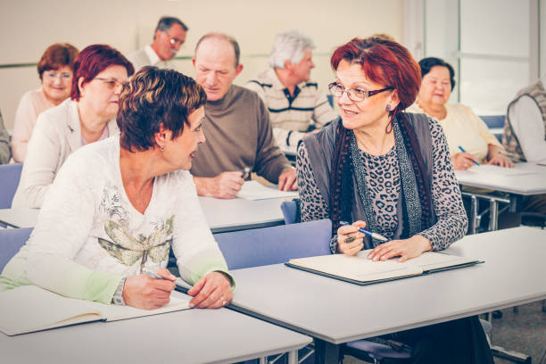 istock Group of happy seniors on motivation seminar 1172563980