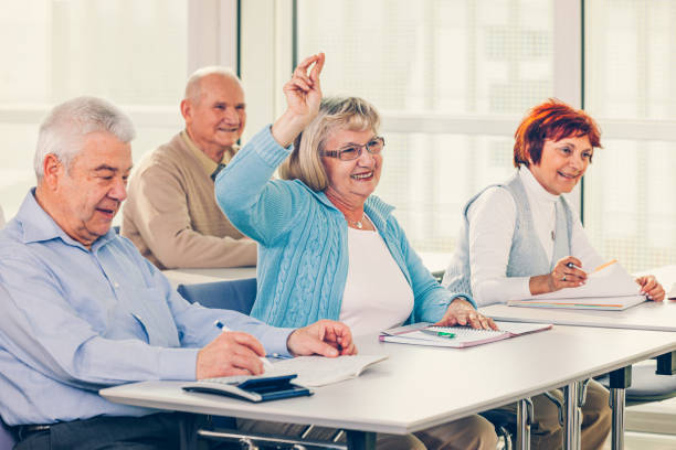 istock Group of happy seniors on motivation seminar 1172564061