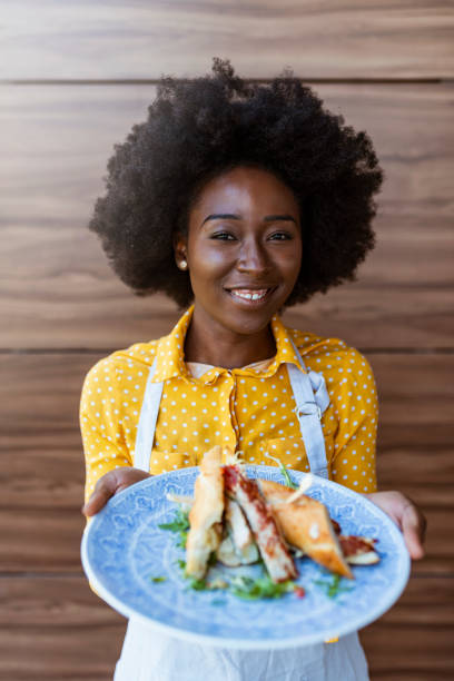 istock Smiling barista holding plate with sandwich 1172564693