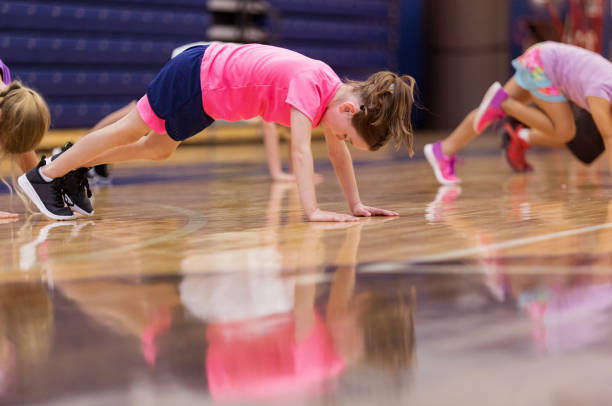 istock Children stretch legs during gym class 1172566702