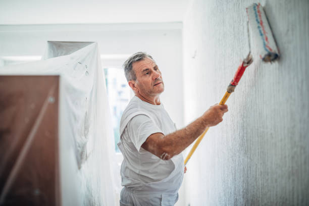 istock Senior worker painting walls 1172567287