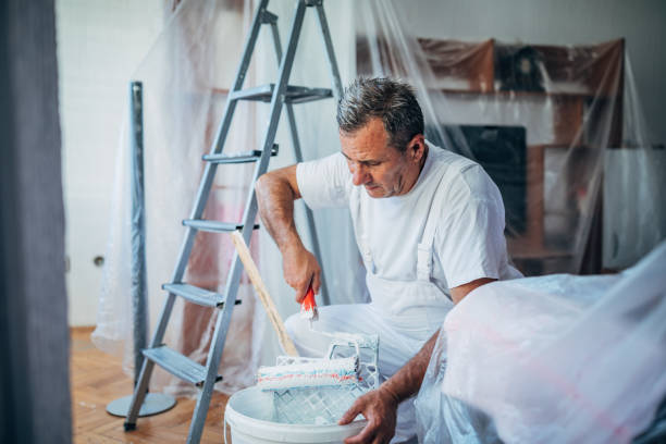 istock Senior worker painting walls 1172567805