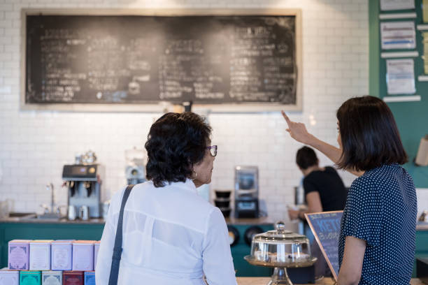 Women looking at coffee shop menu