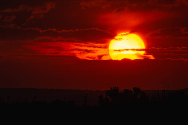 istock big red sun and clouds in the sunset 1172568128