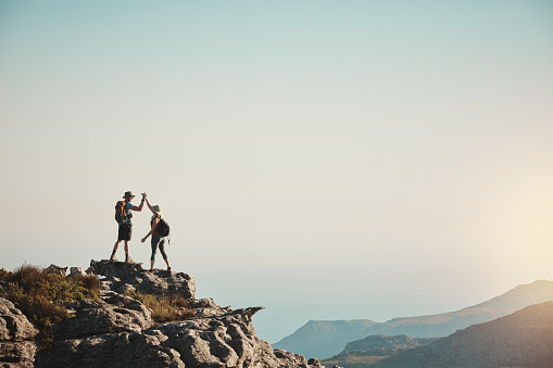 Shot of a man and woman hiking up a mountain