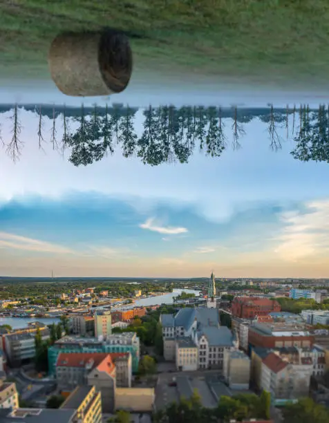 Photomanipulation of cityscape and landscape. Meadow at the top and city at the bottom.