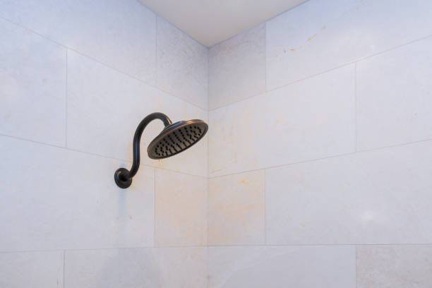 istock Modern shower head in bathroom with new home construction 1172572366