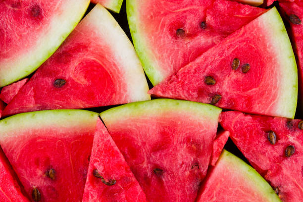 istock Watermelon pattern. Sliced watermelon top view. Ripe watermelon with seeds. Summer creative concept 1172572465