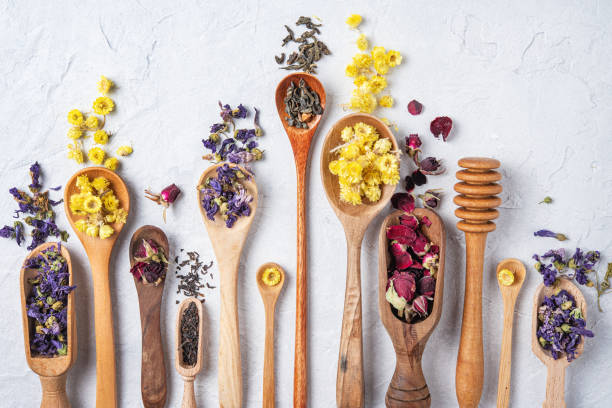 istock some wood spoon with herbal tea lavender, rose and chamomile on light wood table top view 1172573658