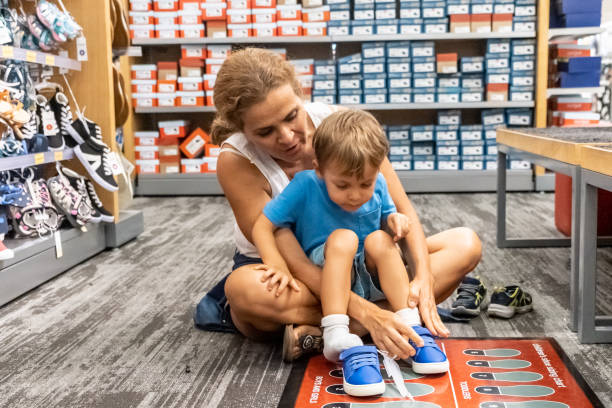 istock Mature woman shopping for shoes for her son 1172575708