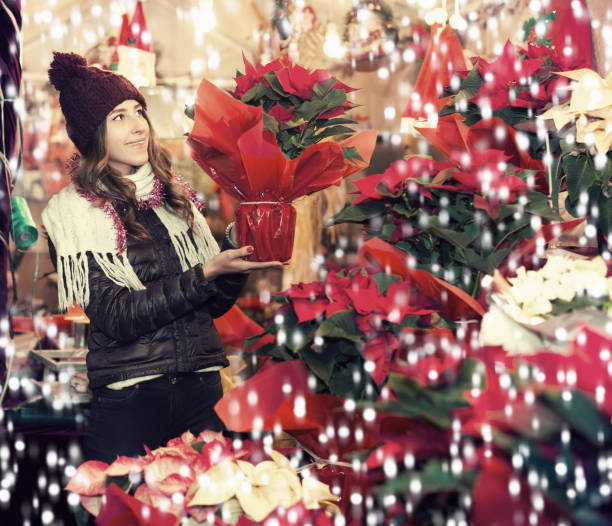 istock Girl buying Christmas floral compositions 1172575920