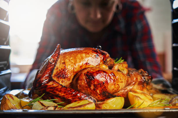 istock Roasting Stuffed Turkey in the Oven for Holidays 1172577138