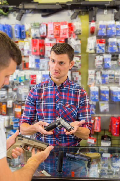 istock Salesman helping customer to choice air gun 1172577213