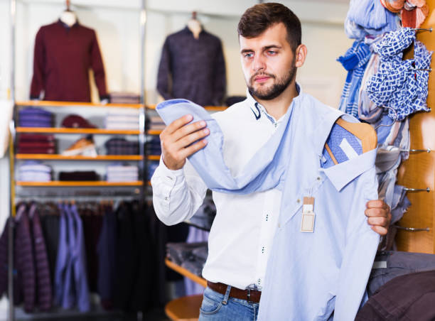 istock Man looking for classic shirt 1172577248