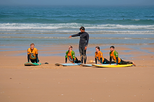 Vale Figueiras, Portugal - April 8, 2019: Surfers getting surfers lessons at praia Vale Figueiras in Portugal