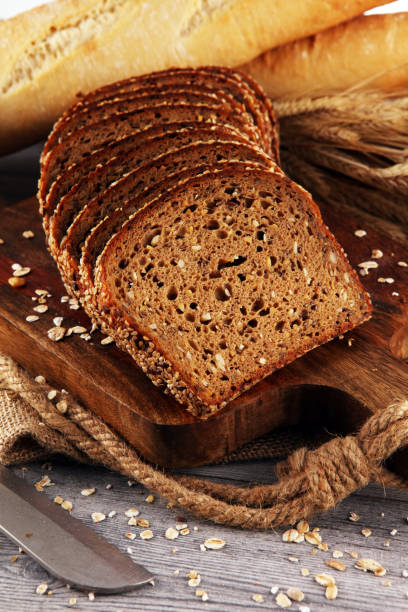 istock freshly baked bread on wooden board. cutted organic bread 1172577533