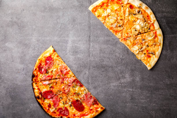 istock Pizza Assortment Pepperoni Salami Bacon Tomatoes  Mozzarella  Four Cheese on  stone Background Bake Spicy Snack Top View Copy space for Text 1172581542