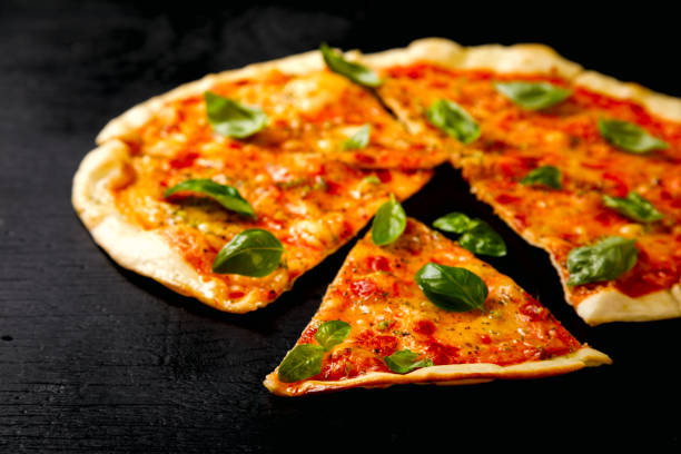 istock Pizza Margarita with Mozzarella and Basil on the Black Background Bake Snack with Tomatoes  Top View Copy space for Text 1172581559
