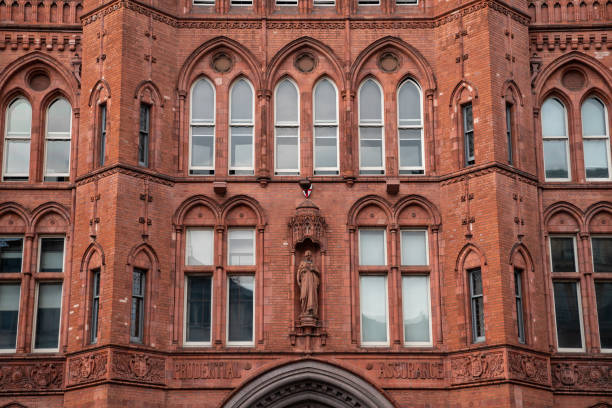 Three rectangular windows with brown frames and arched cornice against a red brick wall. From the windows of the world series.