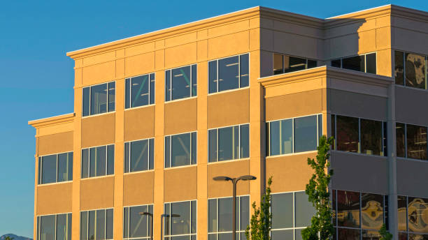 istock Panorama frame Commercial modern building exterior viewed against blue sky on a sunny day 1172581939