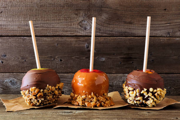 istock Fall candy apples with chocolate and caramel, side view against dark wood 1172583154