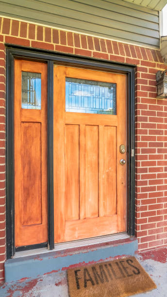 istock Vertical frame Home with brick and wood wall sections and glass paned front door and sidelight 1172583766