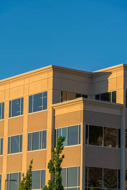 istock Modern building exterior with concrete wall and shiny windows on a sunny day 1172584499