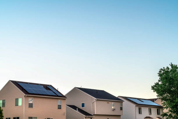 istock Homes with white horizontal siding on wall and solar panels on the rooftops 1172584502