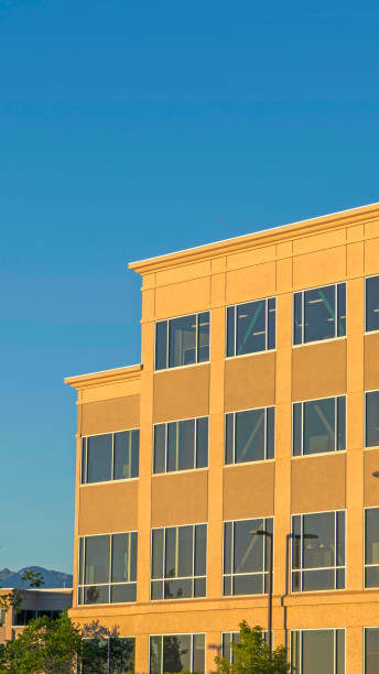istock Vertical Commercial modern building exterior viewed against blue sky on a sunny day 1172584562