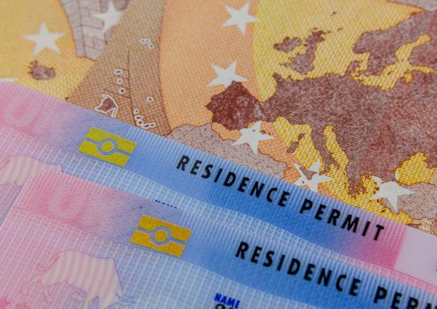 UK Biometrical Residence Permit (BRP) cards and a map of the EU on the Euro banknote. stock photo