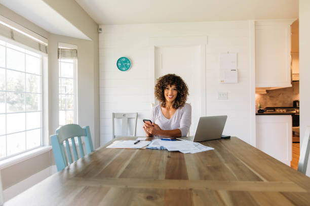 Woman Doing Finances at Home on Smart Phone