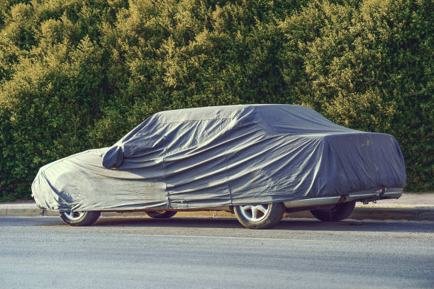 istock A parked car with protective cover in sun weather 1172587300