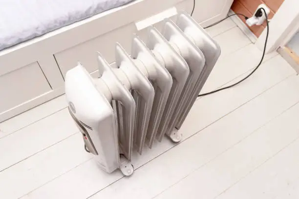 Oil-filled electrical mobile radiator heater for home heating and comfort control in the room.