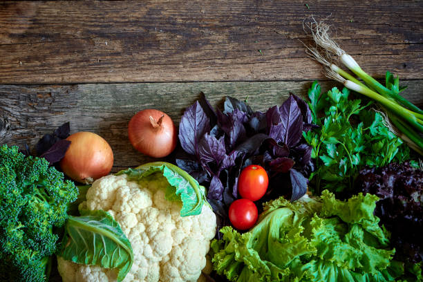 istock Fresh vegetables and herbs on an old rough wooden surface, healthy eating concept, selective focus 1172588283