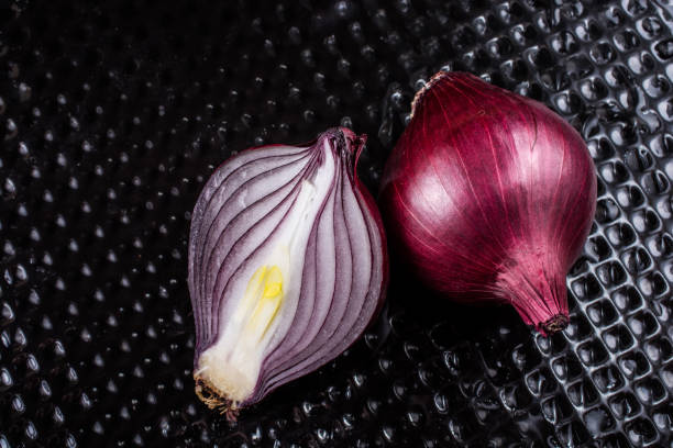 istock Red onion bulb cut in half on certain  background 1172588316