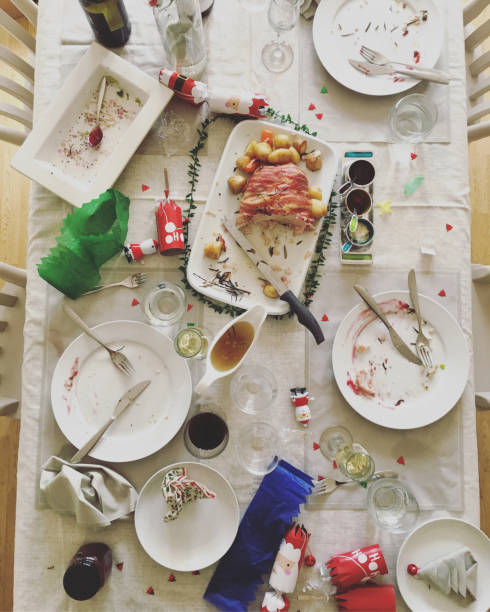 After Christmas celebration, messy dining table Over head view of messy dining table after  Christmas celebration leftovers photos stock pictures, royalty-free photos & images