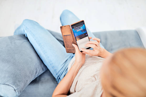 istock Woman using smart-phone inside the apartment. 1172593080