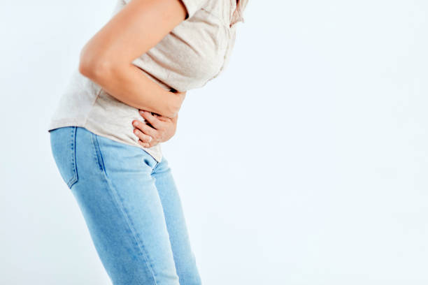istock Woman with stomach/ hip issues / problems on the white background. 1172594286