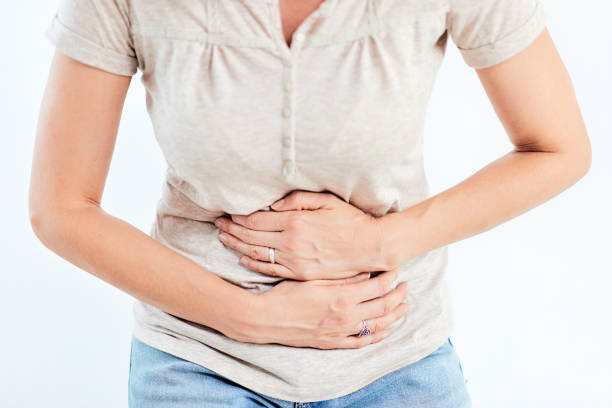 istock Woman with stomach/ hip issues / problems on the white background. 1172594345
